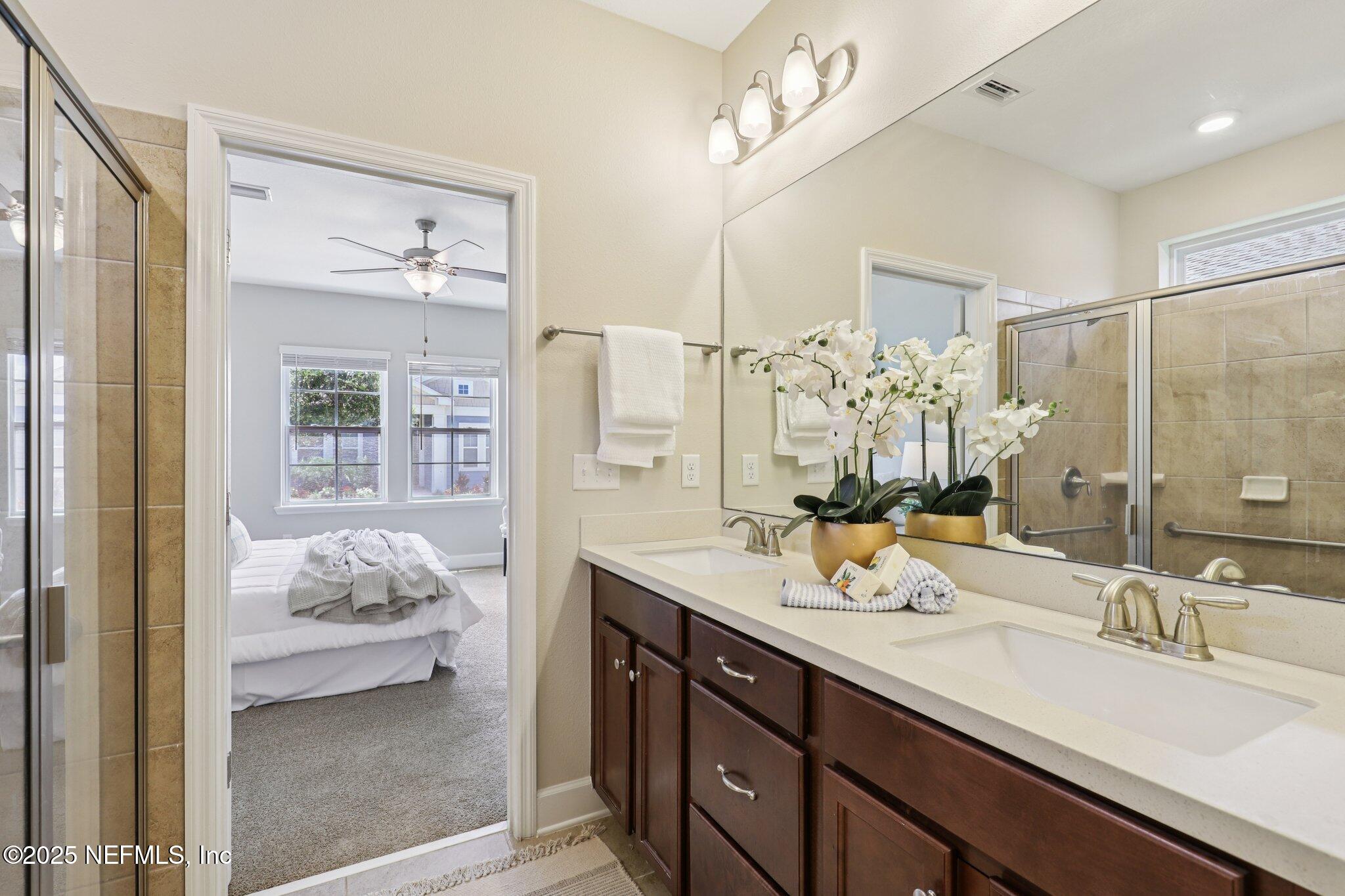 48 Gilchrist Way St. Augustine, FL 32092 - Photo 23 of 50 a en suite bathroom with a double vanity sink mirror and shower