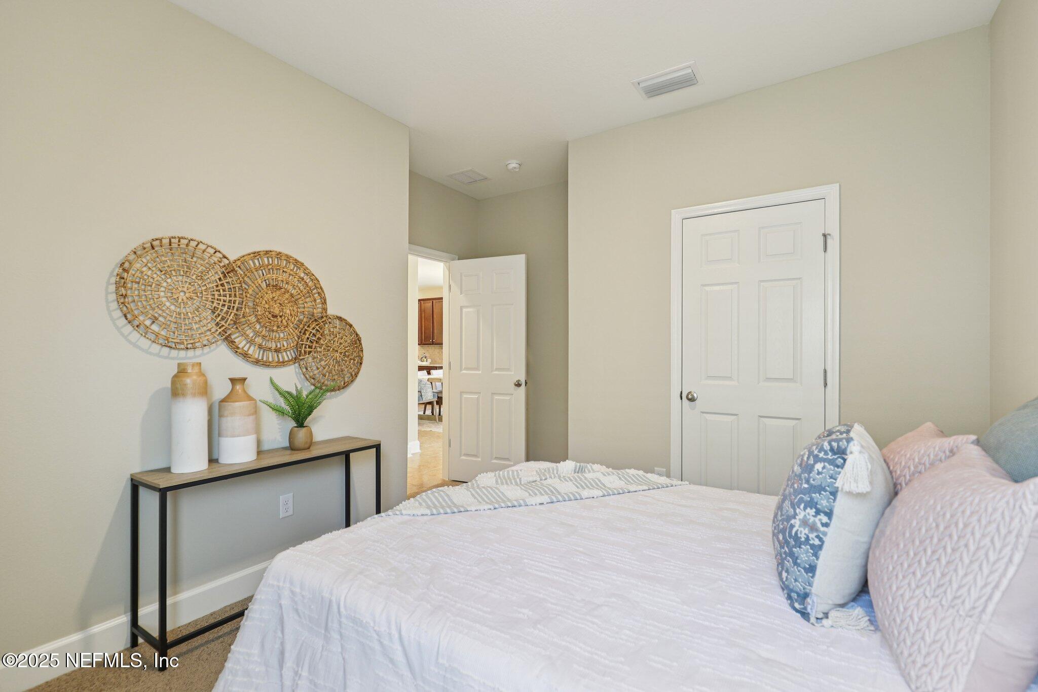 48 Gilchrist Way St. Augustine, FL 32092 - Photo 25 of 50 a bedroom with a bed a mirror and window