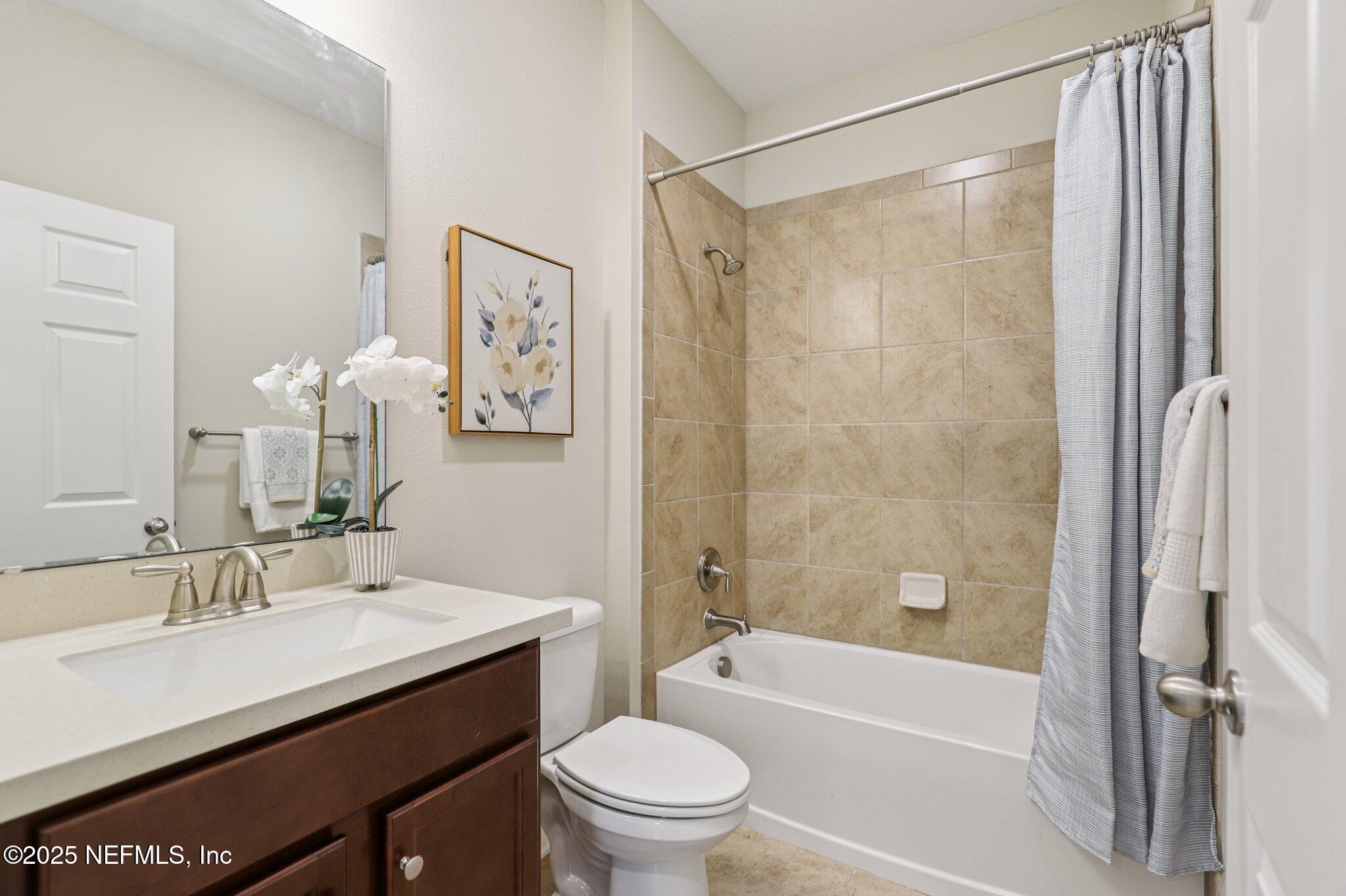 48 Gilchrist Way St. Augustine, FL 32092 - Photo 27 of 50 a bathroom with a sink a toilet a mirror a vanity and shower