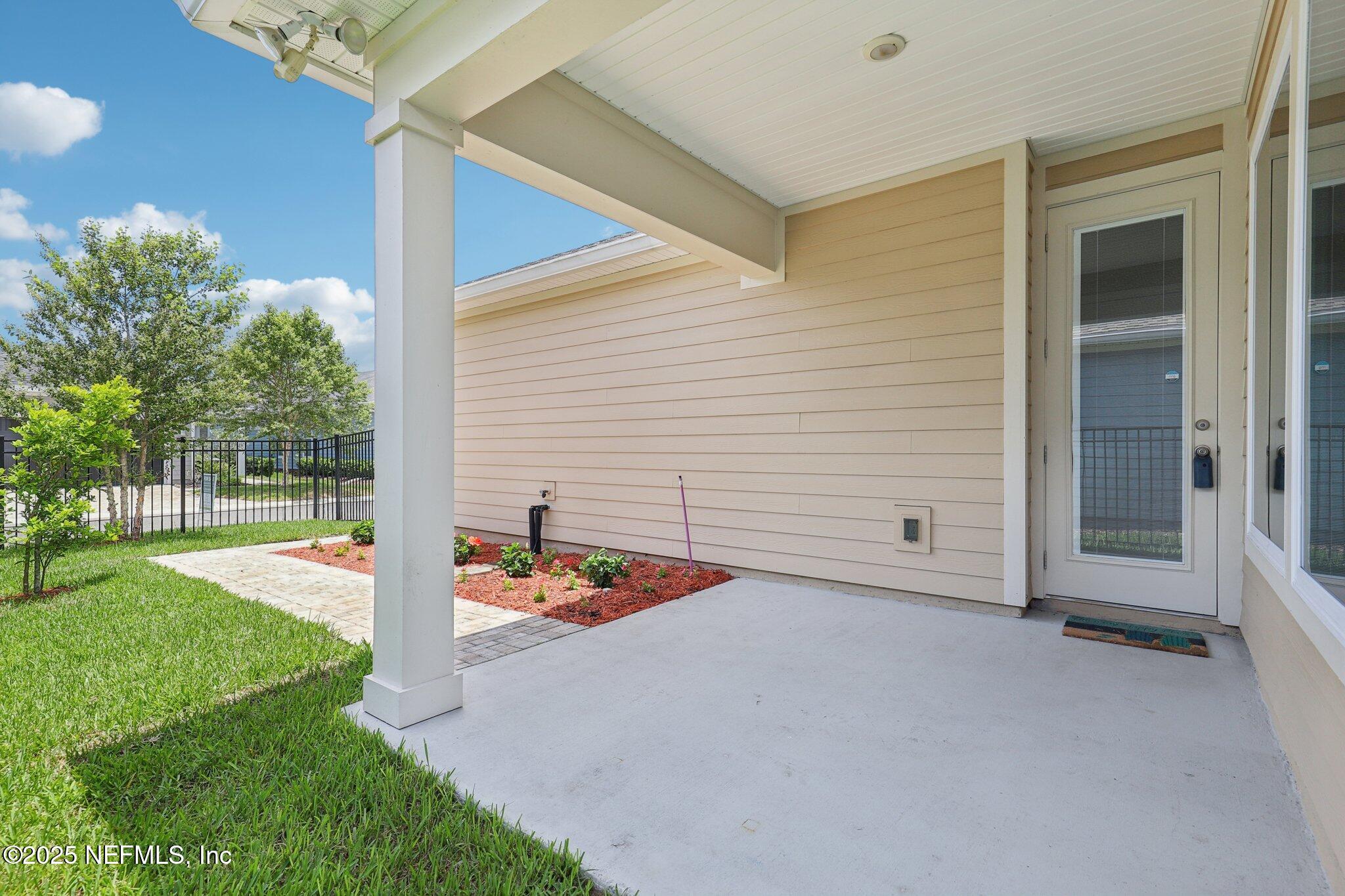 48 Gilchrist Way St. Augustine, FL 32092 - Photo 31 of 50 a backyard of a house with seating space