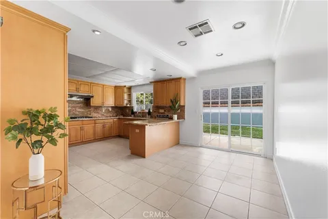 a kitchen with stainless steel appliances a refrigerator sink and cabinets