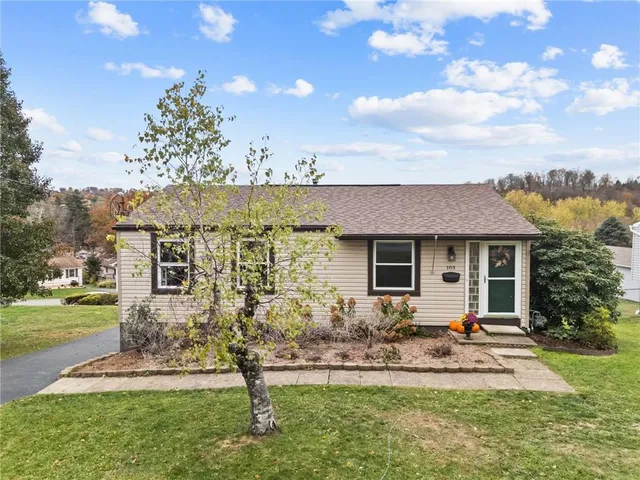 a front view of house with a garden