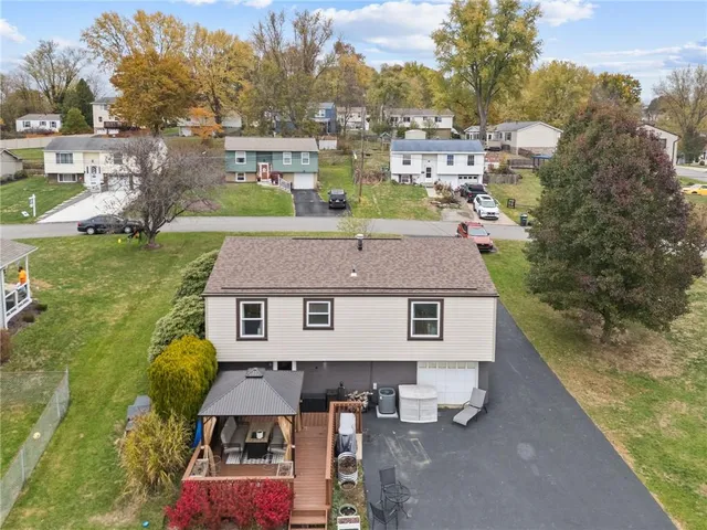 a view of a house with backyard and sitting area