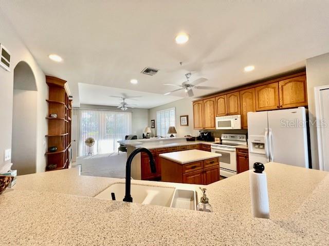 3471 Sunset Key Circle, Unit 102 Punta Gorda, FL 33955 - Photo 18 of 51 a kitchen with stainless steel appliances kitchen island granite countertop a refrigerator and a sink