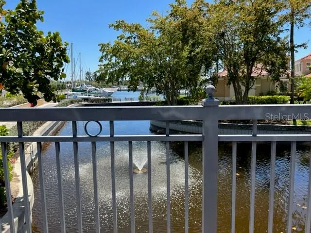 a balcony with table and chairs and a large tree