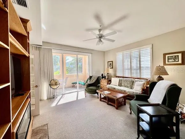 a living room with furniture a chandelier and a window