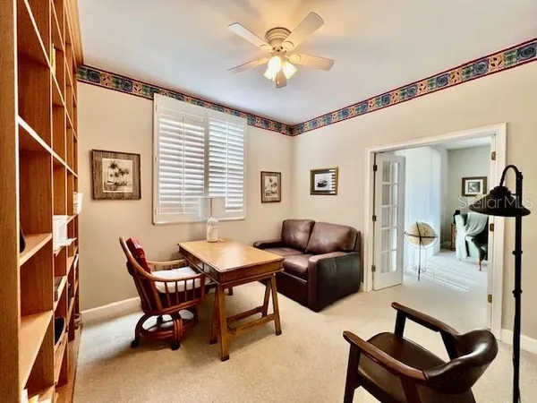 a reading room with furniture and a window