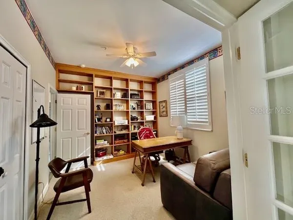 a spacious bedroom with a bed and a large window