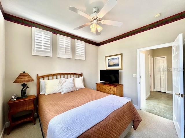 3471 Sunset Key Circle, Unit 102 Punta Gorda, FL 33955 - Photo 30 of 51 a bedroom with a bed and a chandelier