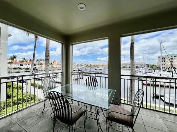 a view of a chairs and table in balcony