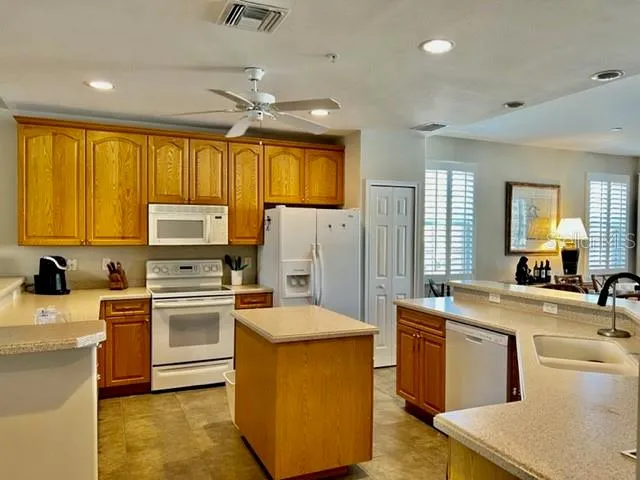 a kitchen with a sink appliances and cabinets