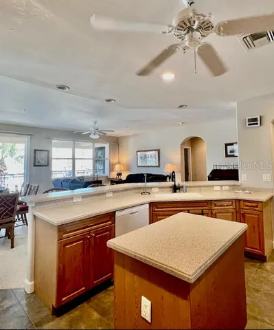 a kitchen with a stove a sink a dining table and chairs