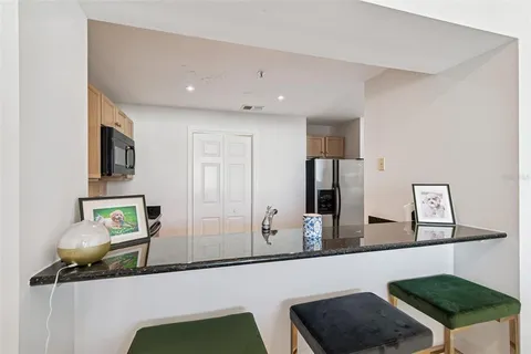 a kitchen with granite countertop a sink and a stove top oven