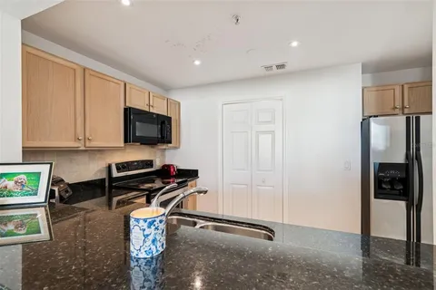 a kitchen with stainless steel appliances granite countertop a sink stove and microwave