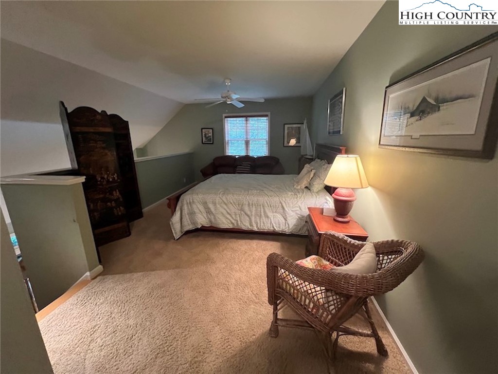 135 Caleb Drive, Unit 4 Blowing Rock, NC 28605 - Photo 11 of 19 a bedroom with a bed and wooden floor