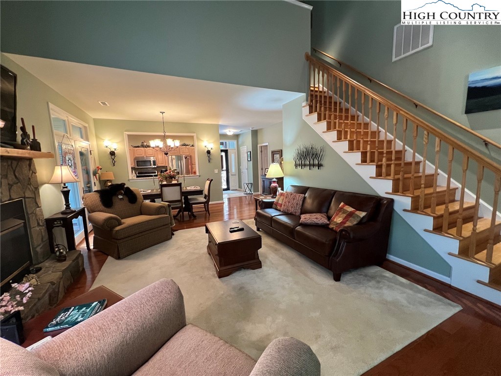 135 Caleb Drive, Unit 4 Blowing Rock, NC 28605 - Photo 12 of 19 a living room with furniture and a dining table with wooden floor