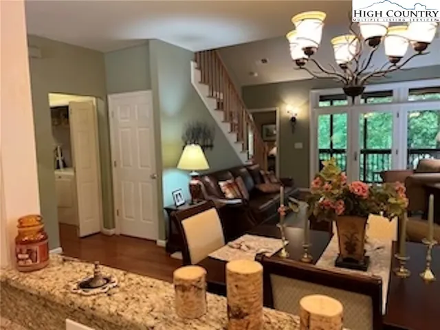 a living room with furniture fireplace and large windows