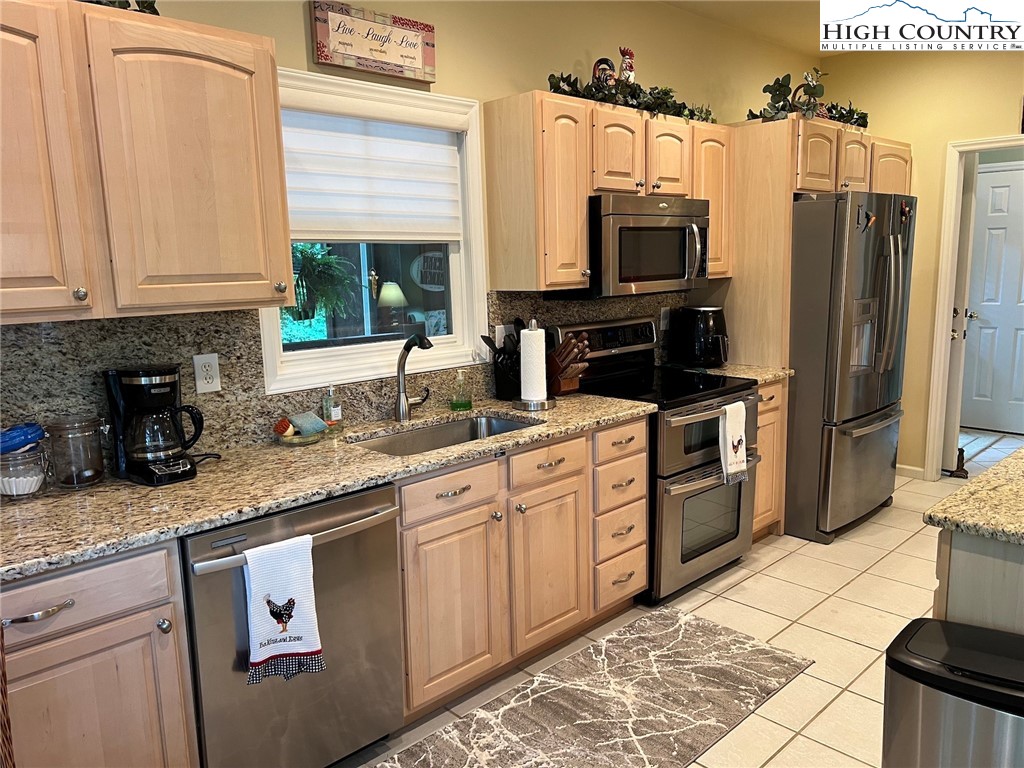 135 Caleb Drive, Unit 4 Blowing Rock, NC 28605 - Photo 7 of 19 a kitchen with stainless steel appliances granite countertop a refrigerator sink and stove