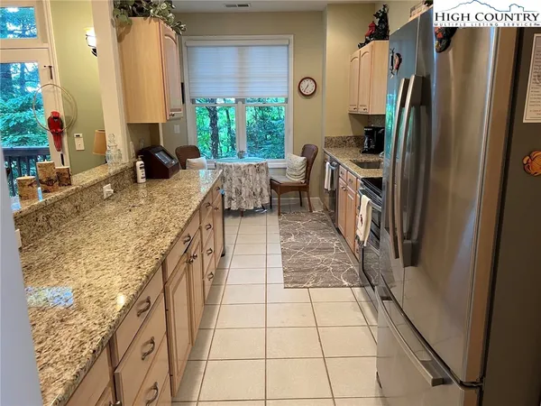 a bedroom with a bed flat screen tv and dresser