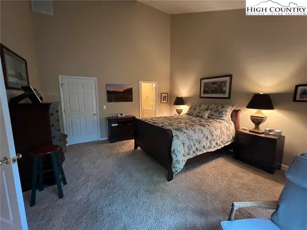 a bedroom with a bed and dresser with mirror