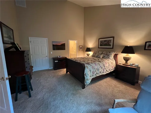 a bedroom with a bed and dresser with mirror