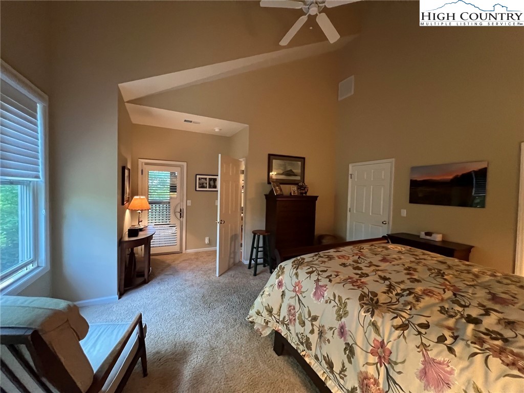 135 Caleb Drive, Unit 4 Blowing Rock, NC 28605 - Photo 10 of 19 a bedroom with a bed and dresser with mirror