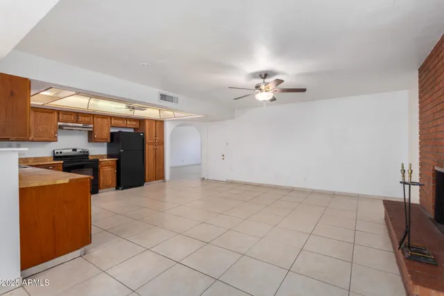 a view of kitchen with furniture and a refrigerator