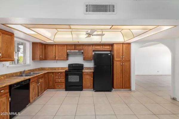 a kitchen with stainless steel appliances granite countertop a refrigerator and a sink