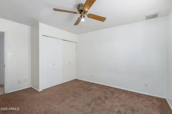 an empty room with a fan