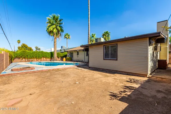 a view of a house with a backyard