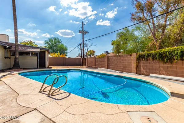 a view of a swimming pool with a patio
