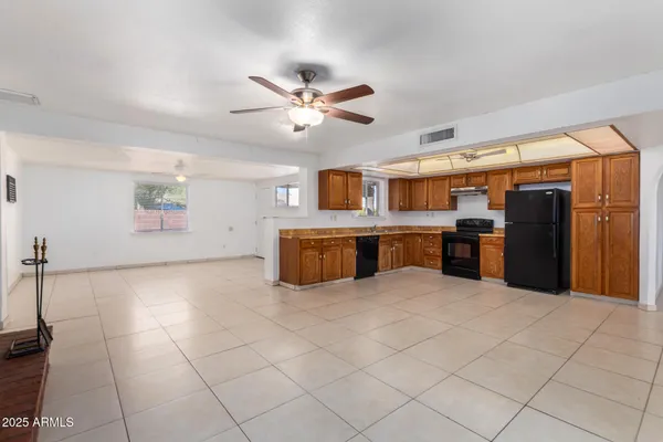 a large kitchen with cabinets and stainless steel appliances