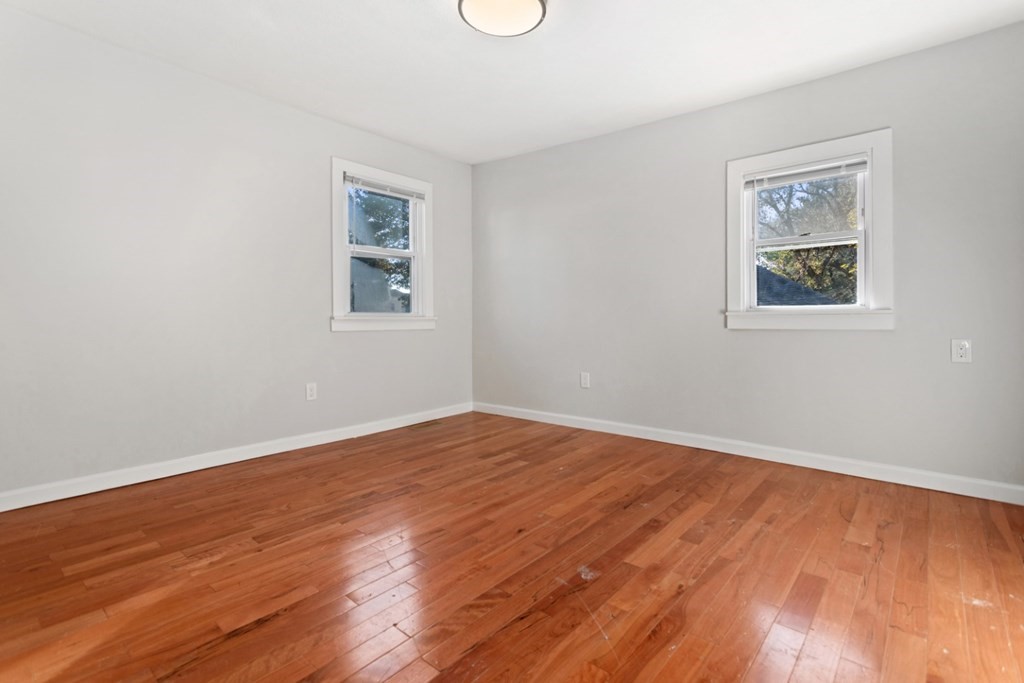 28 Warren Street Peabody, MA 01960 - Photo 18 of 37 a view of an empty room with wooden floor and a window