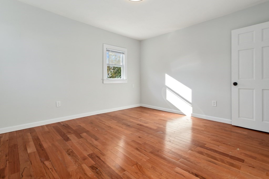 28 Warren Street Peabody, MA 01960 - Photo 25 of 37 a view of an empty room with wooden floor and a window