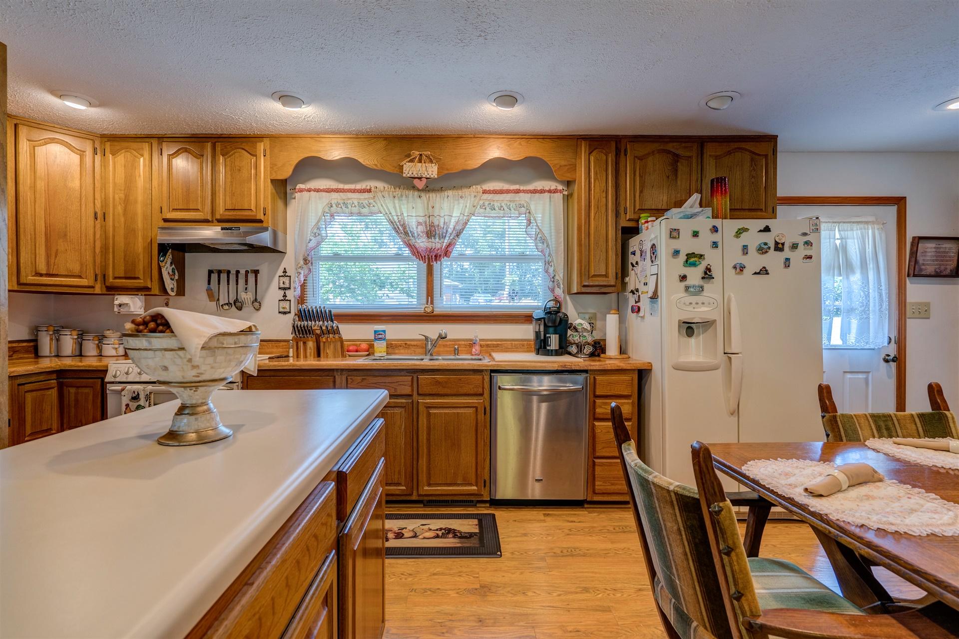 5756 White House Road Moneta, VA 24121 - Photo 11 of 35 a kitchen with stainless steel appliances wooden floor and a refrigerator
