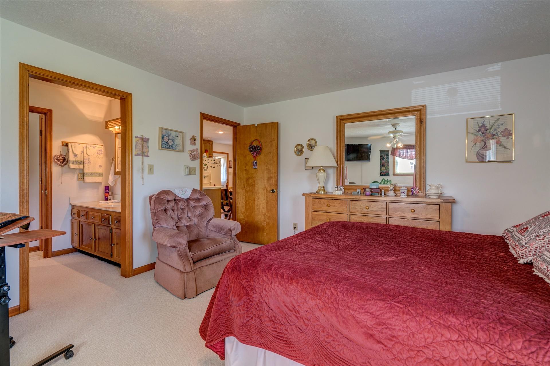 5756 White House Road Moneta, VA 24121 - Photo 15 of 35 a bedroom with bed and glass door