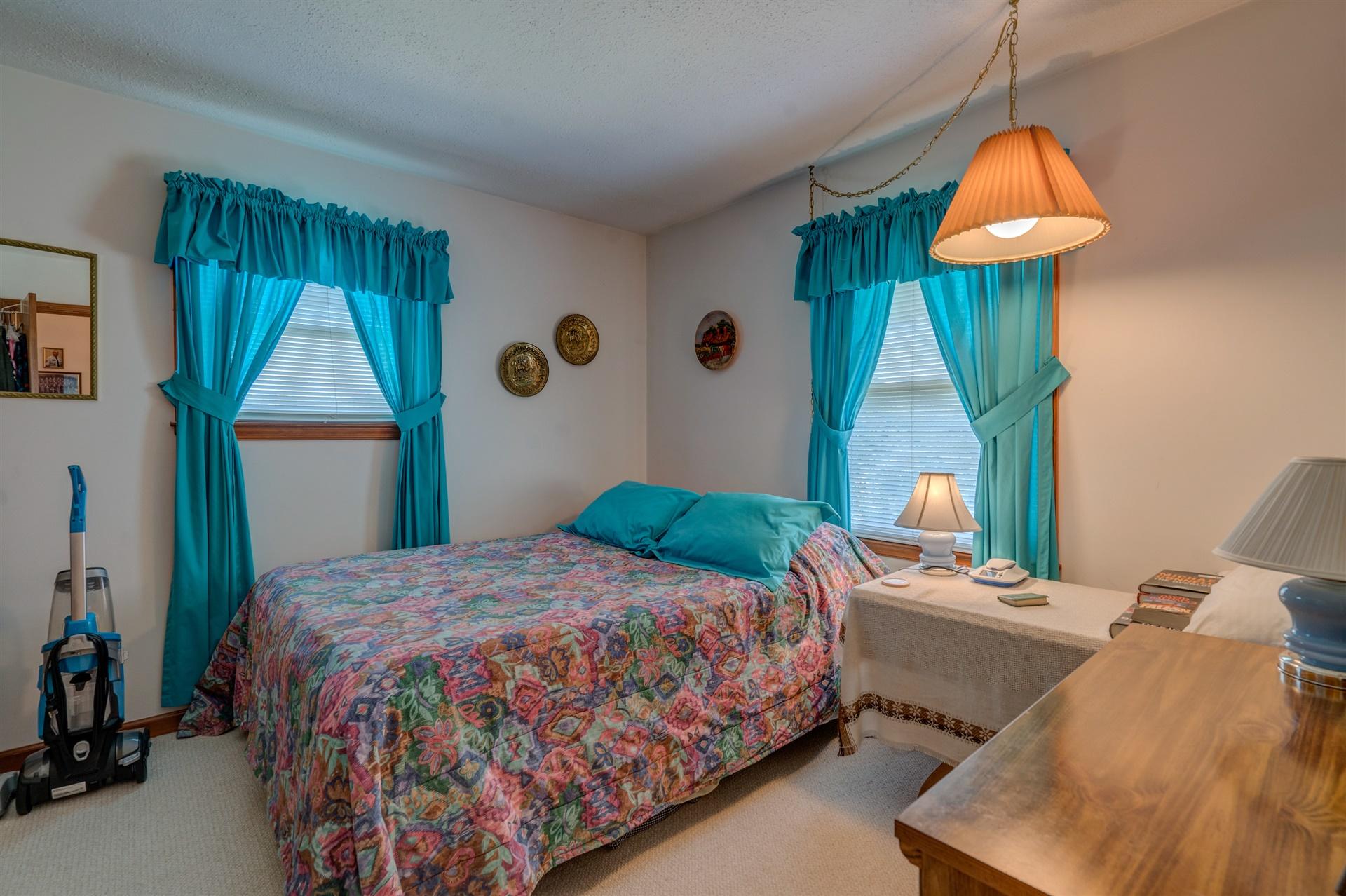5756 White House Road Moneta, VA 24121 - Photo 19 of 35 a bedroom with a bed a mirror and a window