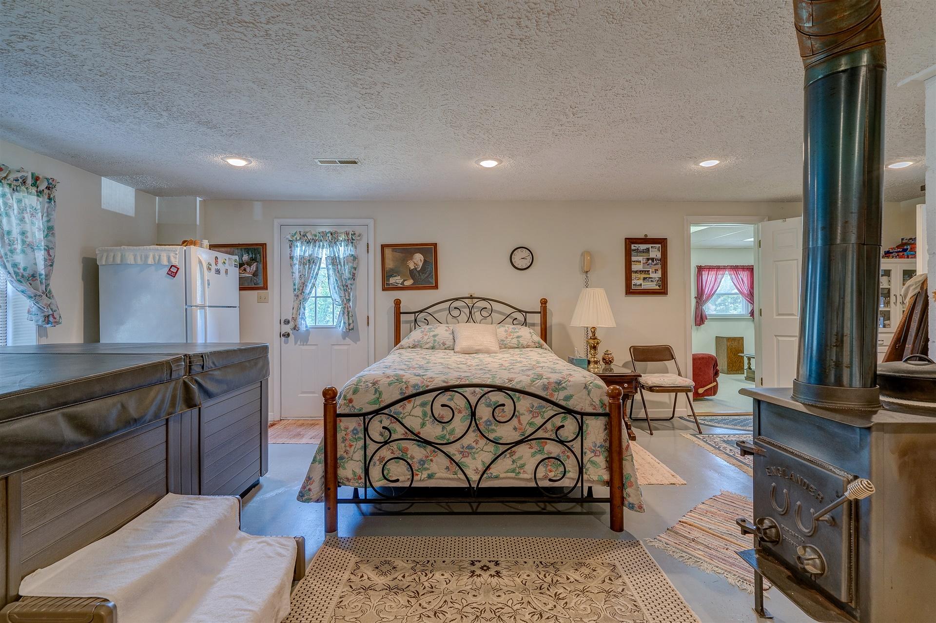 5756 White House Road Moneta, VA 24121 - Photo 22 of 35 a bedroom with furniture and a flat screen tv