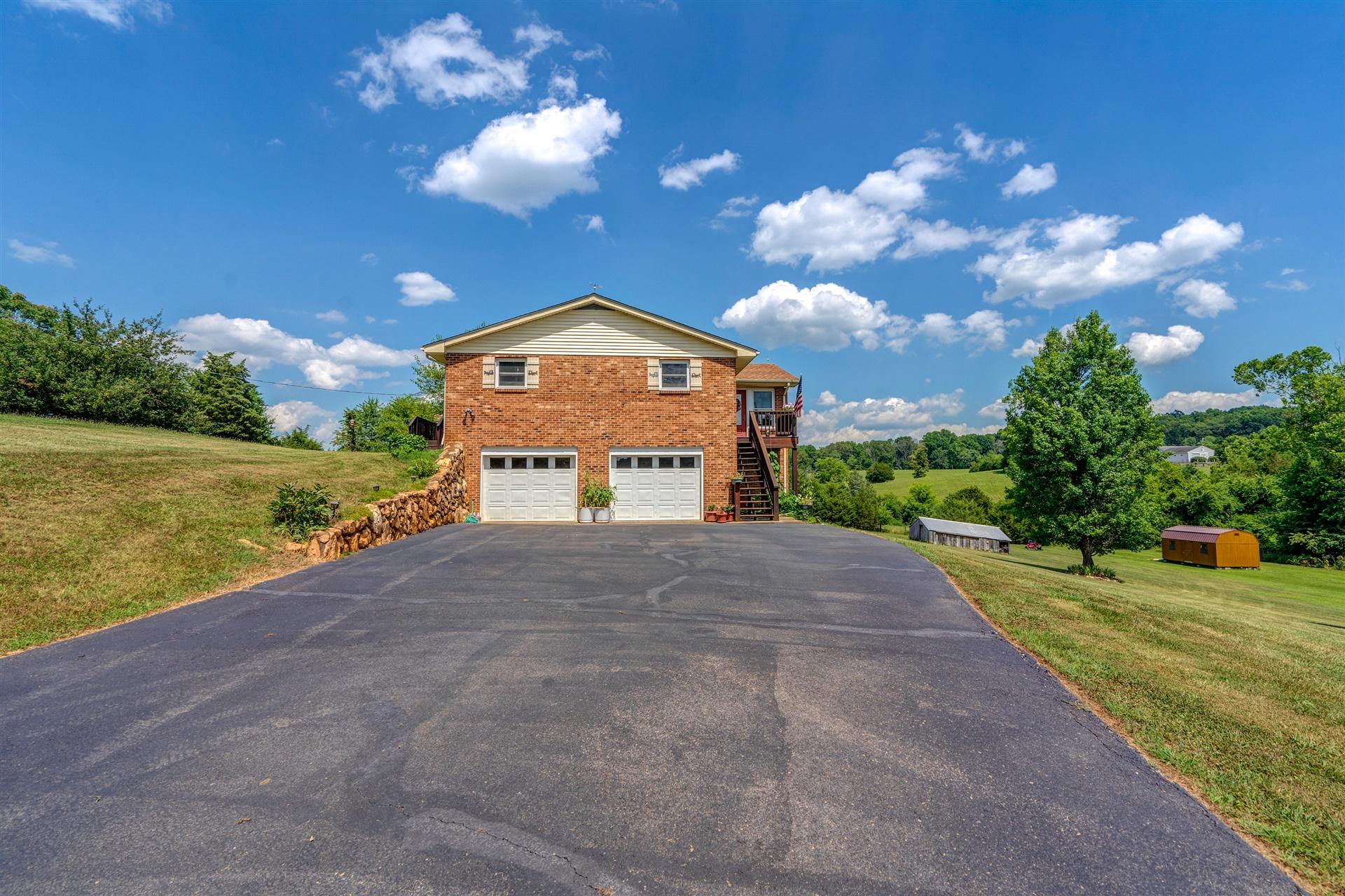 5756 White House Road Moneta, VA 24121 - Photo 32 of 35 a front view of a house with a yard and garage