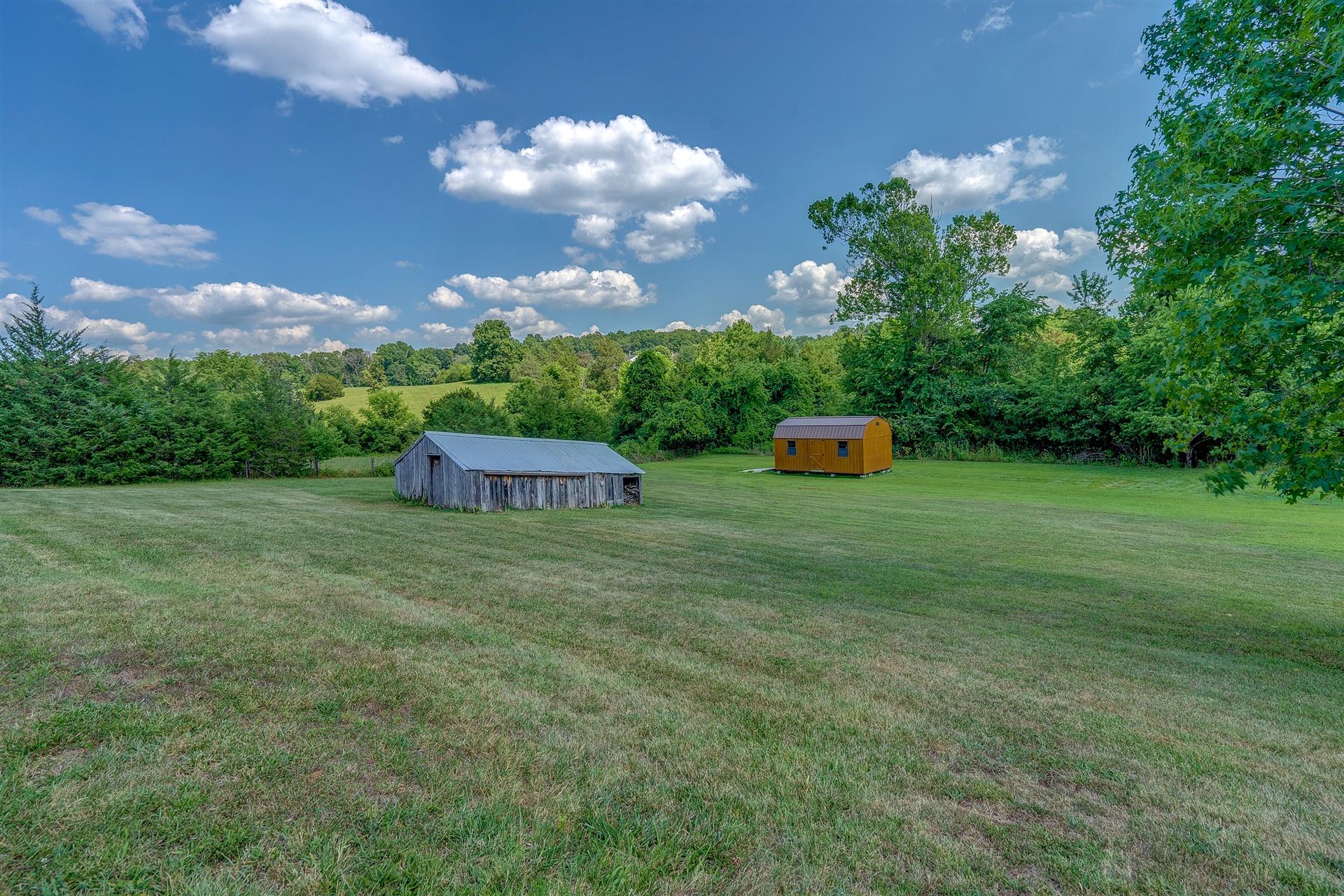 5756 White House Road Moneta, VA 24121 - Photo 5 of 35 a backyard of a house with a garden and barbeque oven