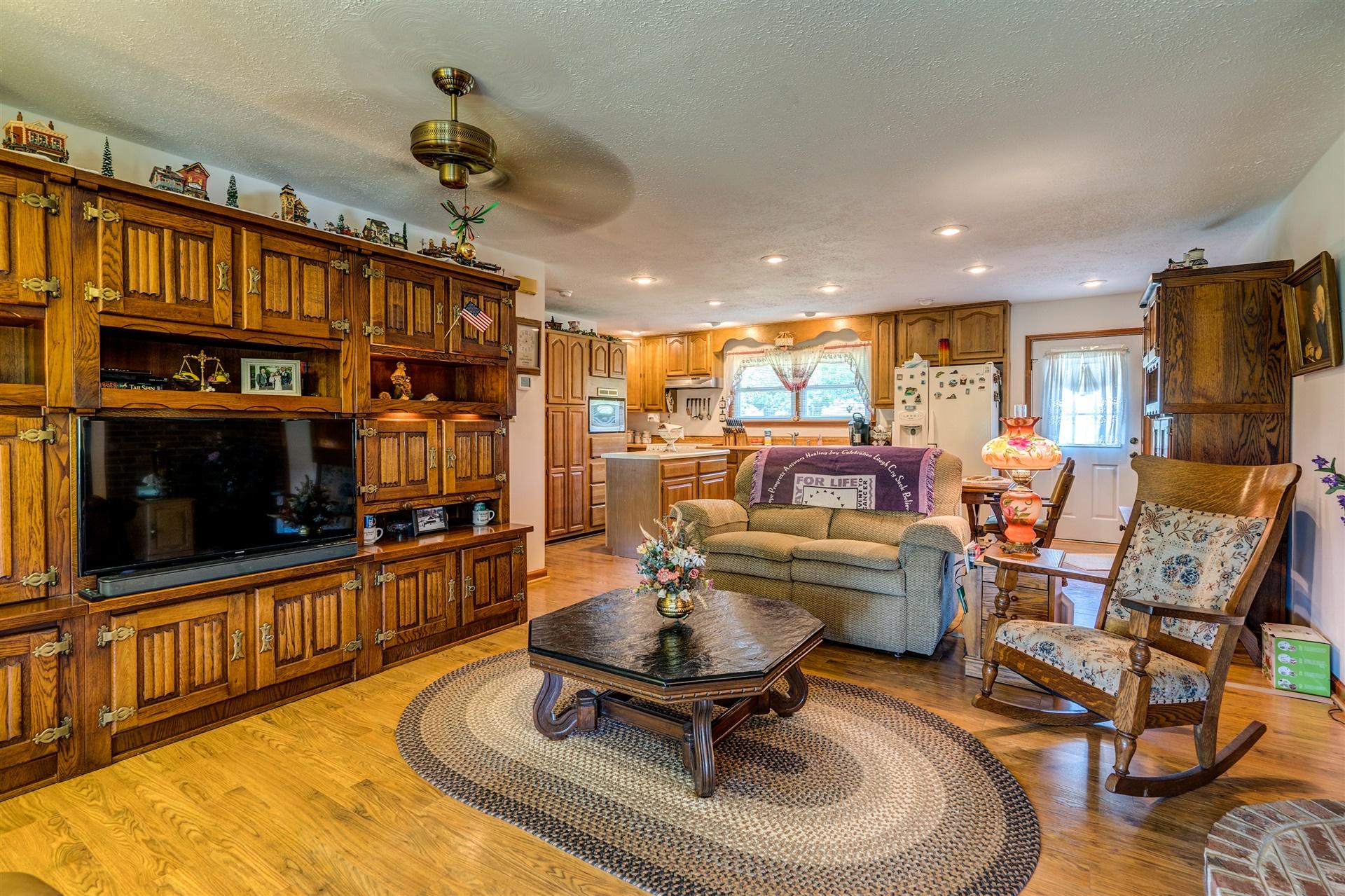 5756 White House Road Moneta, VA 24121 - Photo 7 of 35 a living room with furniture a flat screen tv and kitchen view