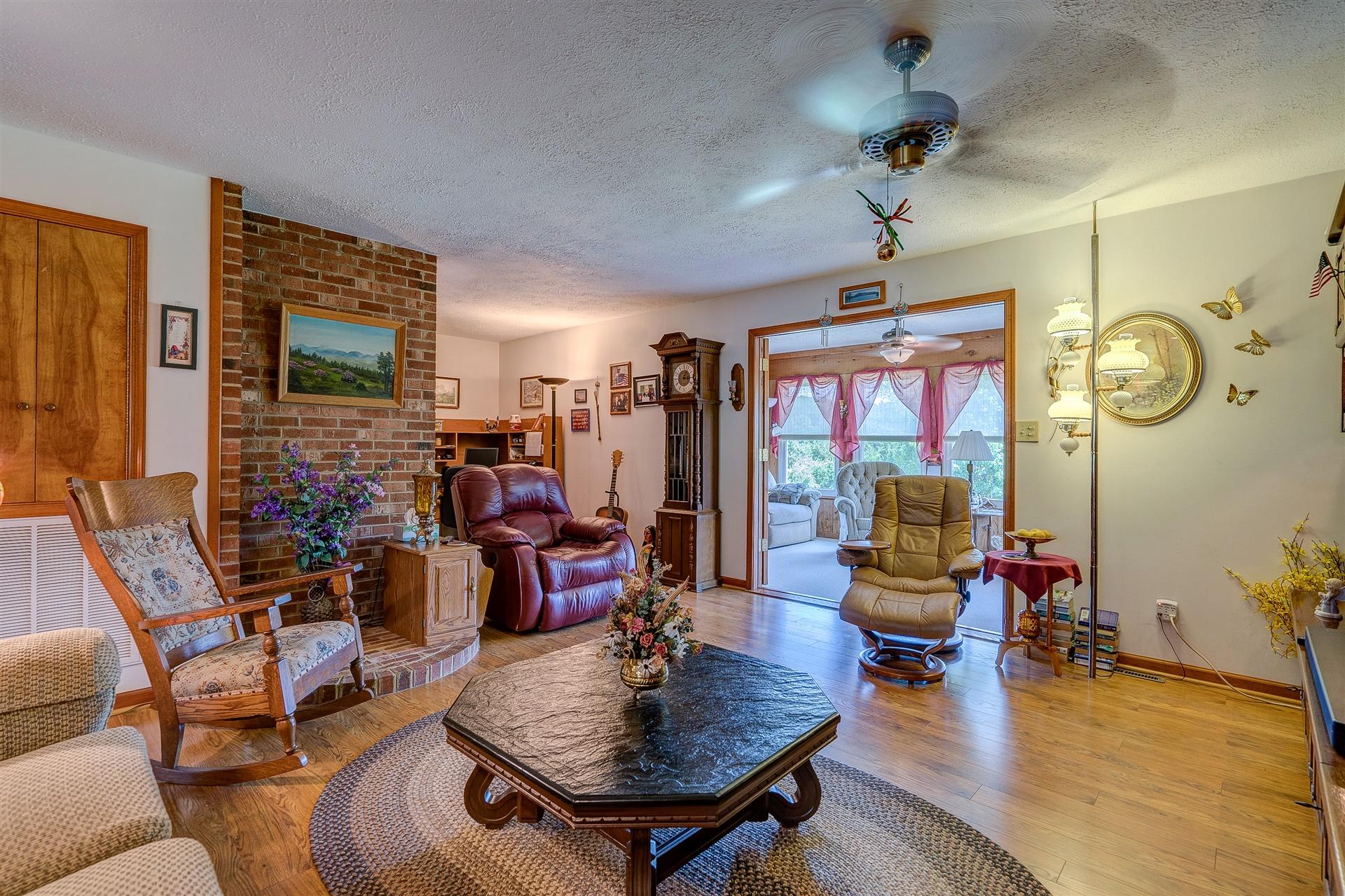 5756 White House Road Moneta, VA 24121 - Photo 10 of 35 a living room with furniture a rug and a chandelier