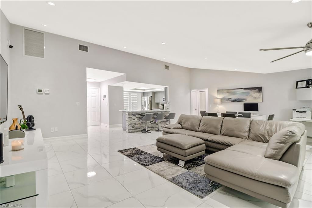5131 31st Place Southwest Naples, FL 34116 - Photo 8 of 24 a living room with furniture and a table