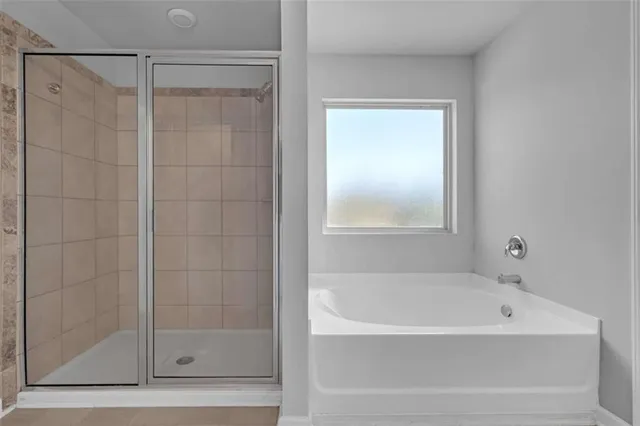a white bath tub sitting next to a shower