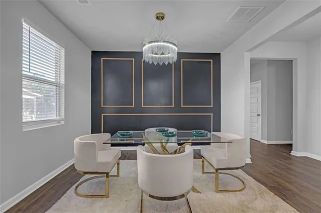 a dining room with furniture and wooden floor