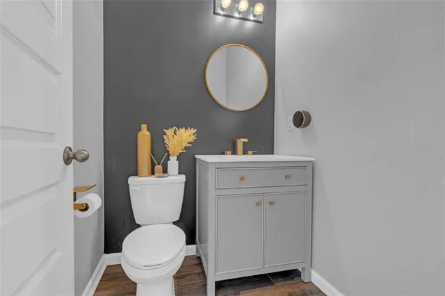 a bathroom with a toilet a sink and mirror