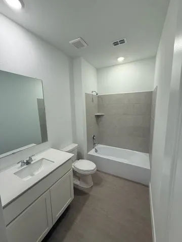 a bathroom with a double vanity sink toilet and shower