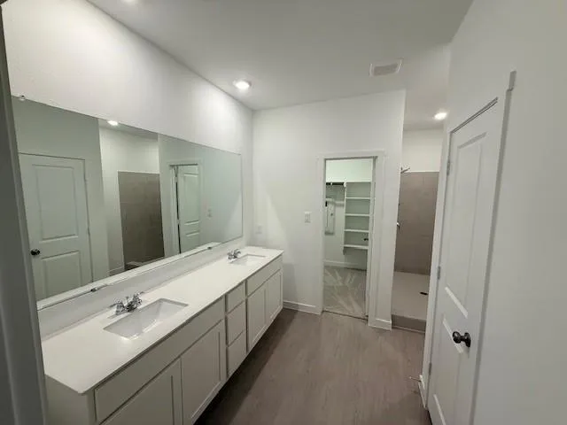 a bathroom with a double vanity sink and mirror