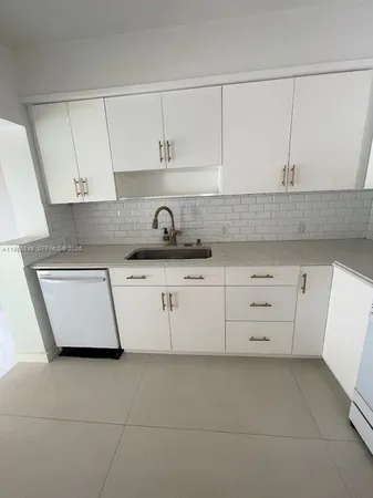 a kitchen with white cabinets