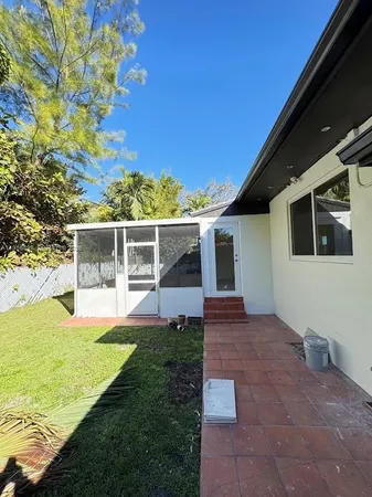 a view of house with backyard